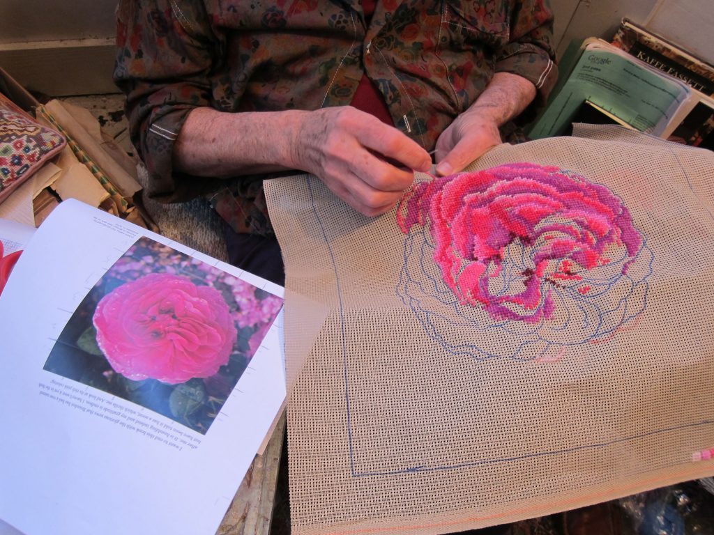 Rose needlepoint in progress by Kaffe Fassett