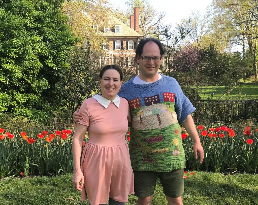 Sam Barsky and his wife showing off another one of Barsky's knitted creations