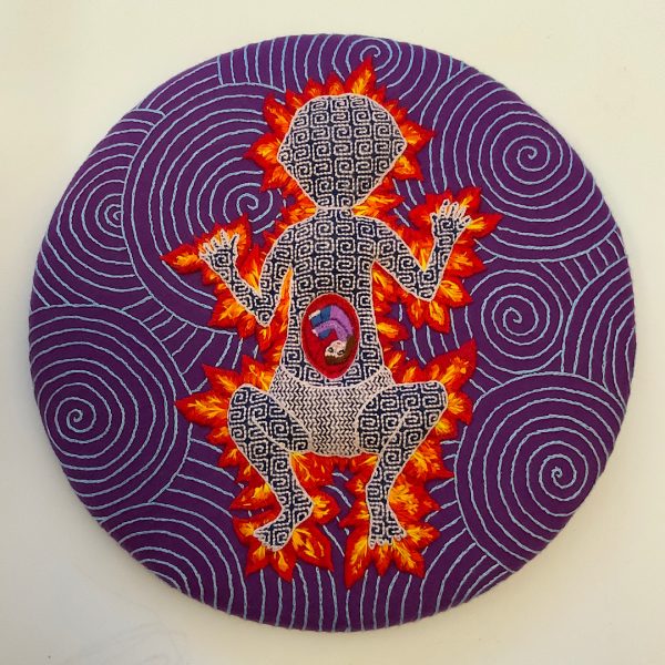 Hand embroidery assessment piece by Annie Davidson, featuring patterned figure outlined by fire with a human curled up in their stomach