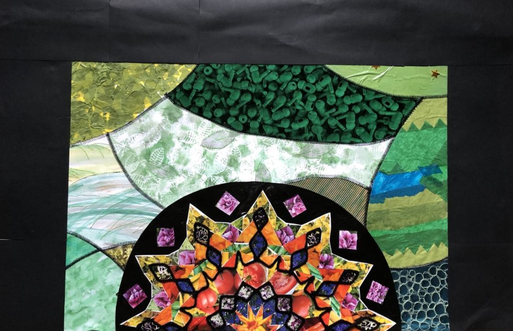 Close up of a patchwork quilting piece, featuring a circle with a geometric star design against a textured green background