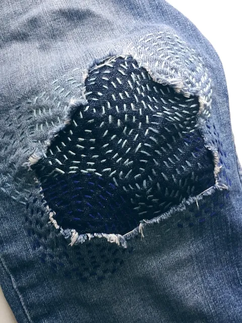 Stitched up embroidered jeans, by Eric Eggenburg