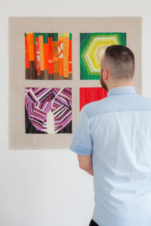 Nicholas Ball viewing his quilts at an exhibition