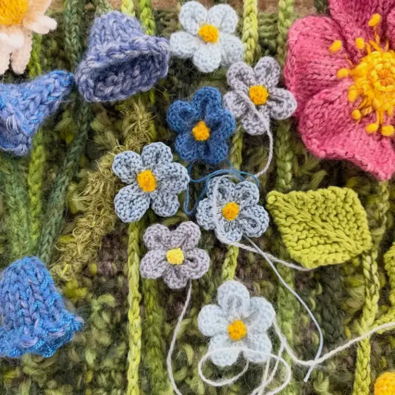 Beautiful knitted flower composition by Cilla, one of our advanced knitting students who is studying skill stage 4