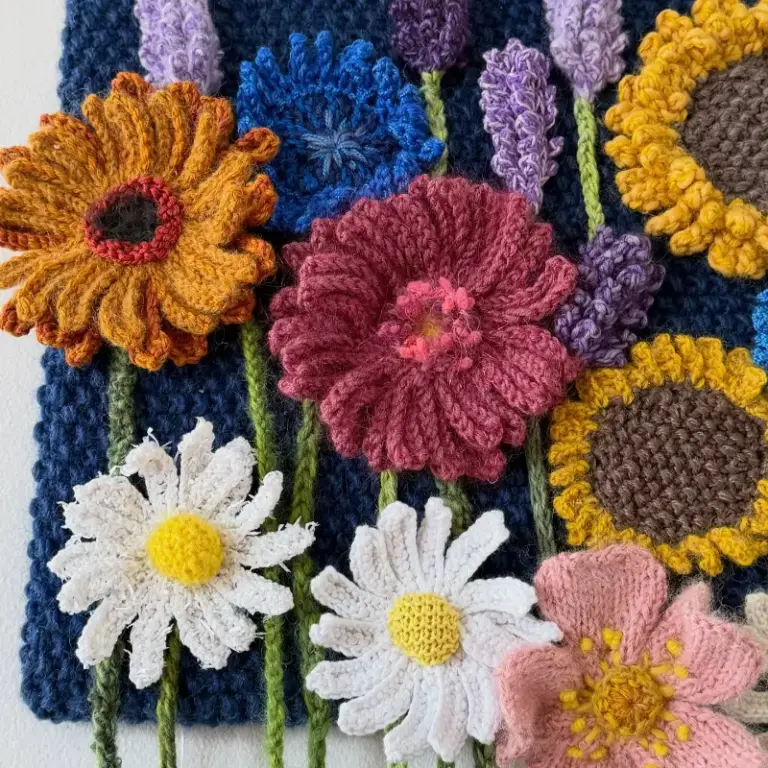 Beautiful knitted flower composition by Cilla, one of our advanced knitting students who is studying skill stage 4