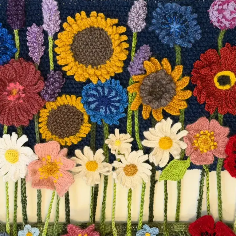 Beautiful knitted flower composition by Cilla, one of our advanced knitting students who is studying skill stage 4