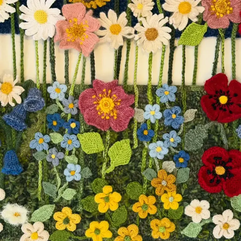 Beautiful knitted flower composition by Cilla, one of our advanced knitting students who is studying skill stage 4