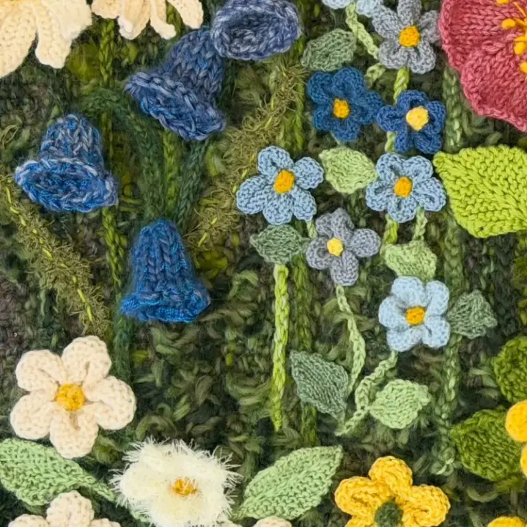Beautiful knitted flower composition by Cilla, one of our advanced knitting students who is studying skill stage 4
