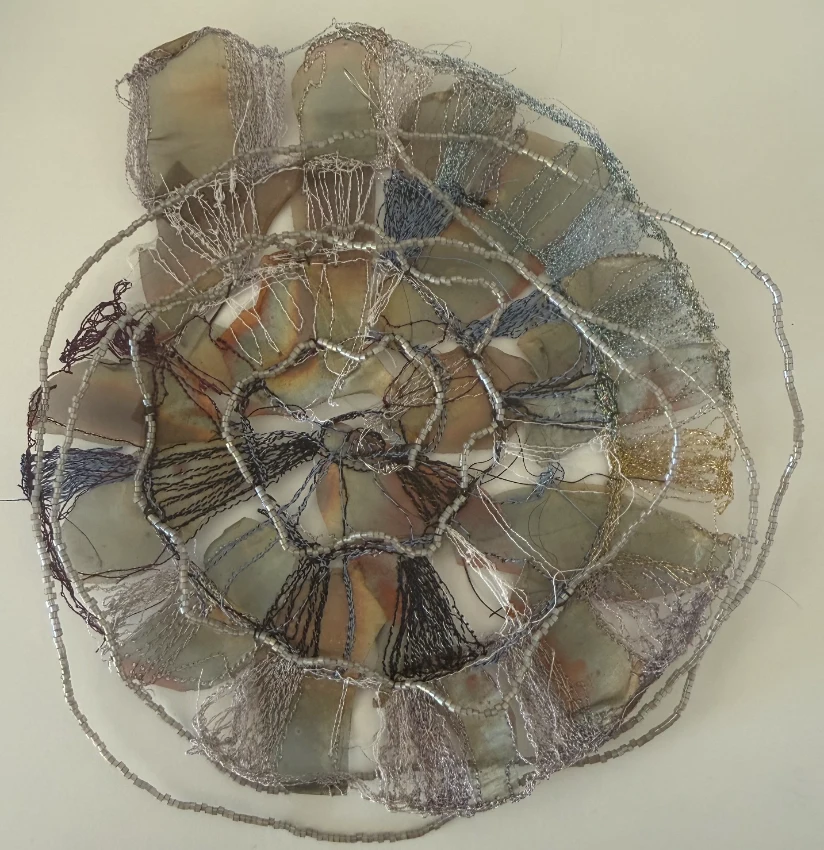 Circular wired textile sculpture with radiating sections in mixed media, by SST graduate Cheryl McNay